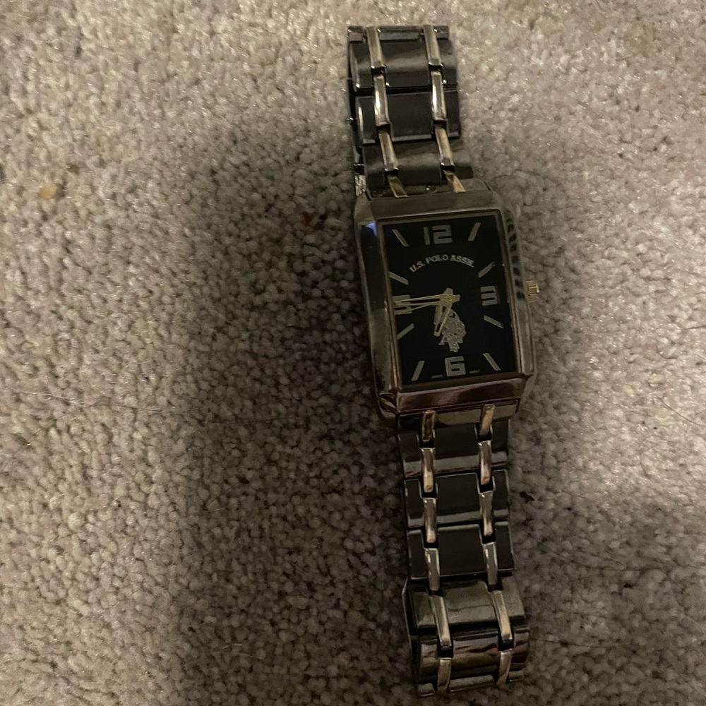 Silver polo assassin watch